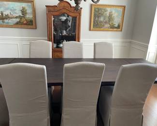 Double-pedestal plank dining table with extension leaves (total length 120" x 42" by 30" with extensions) - 84" w/o extensions. 6 Parson's-styled dining chairs, French Vitrine, and paintings.