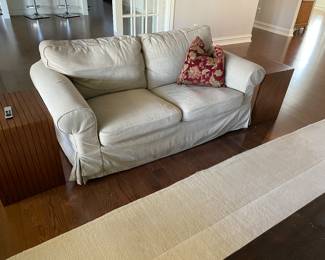 Slip covered couch - ivory (71" x 33" x 29") - matched set of 2 available, shown with MCM side tables (nesting set of 2 - with 2 sets available) and in front the ivory rug (9' x 12')