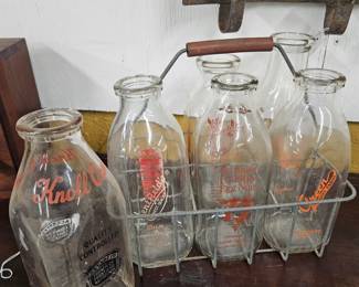 6 glass milk jugs with metal antique carrier