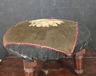 Small antique footstool with needlepoint top