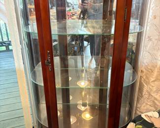 Two of these curved glass curio cabinets
