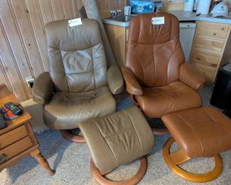 Leather reclining chairs and foot stools.