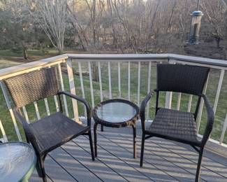 Wicker-type patio chairs and glass table.
