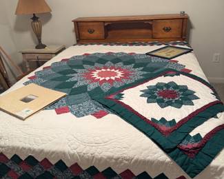 queen size bed with handmade quilt and pillow shams