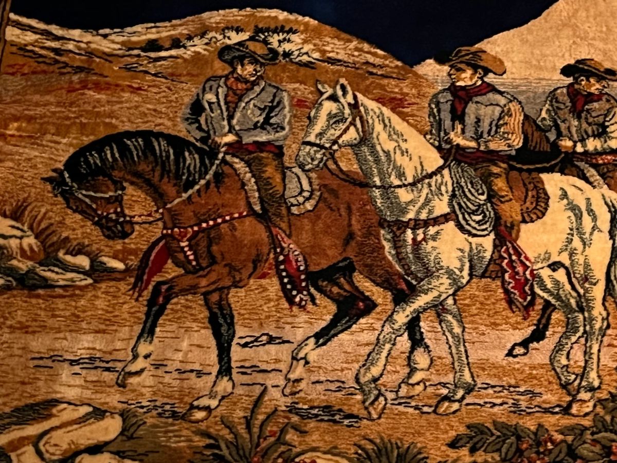 An amazing framed tapestry of cowboys