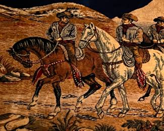 An amazing framed tapestry of cowboys