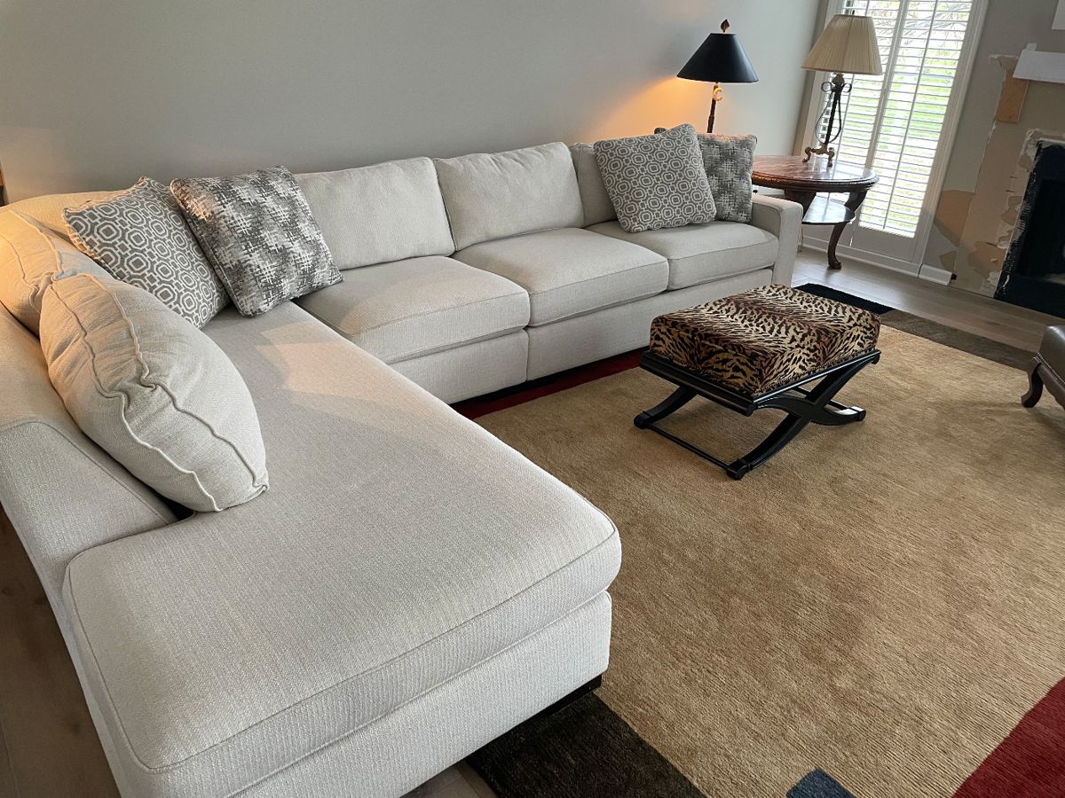 Sectional couch with return on left and large area rug