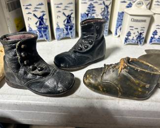 Victorian style toddler button shoes, and one bronze toddler shoe.