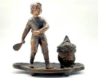 Spelter single inkwell figure of boy with racquet