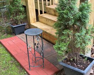 Potted arborvitae and metal plant stands