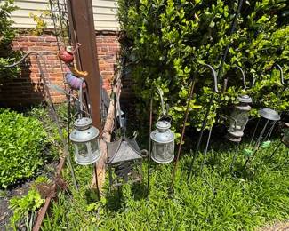 Shepherd's Hooks with hanging lanterns.