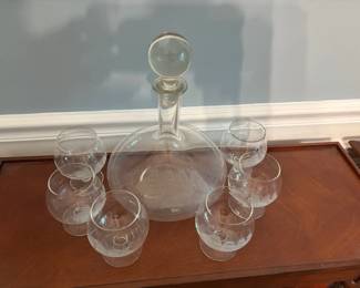 Decanter set with six ship etched glasses.