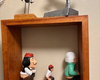 Figures in shadow box.