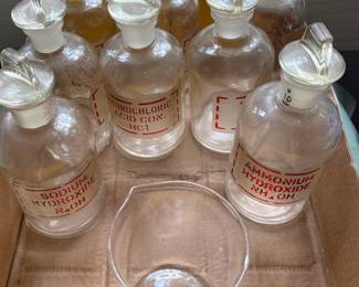 Vintage Pyrex apothecary chemistry bottles with stoppers.
