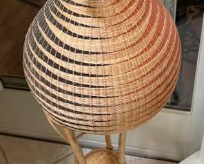 Hand woven basket on a stand.