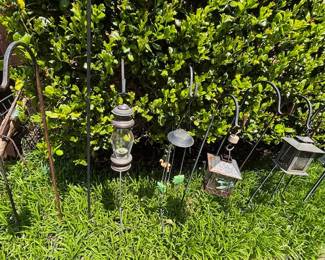 Shepherd's Hooks with hanging lanterns.