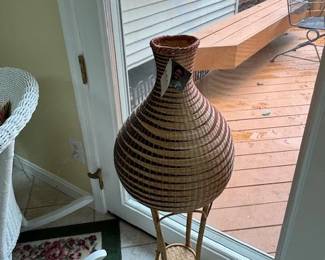 Kazi hand-woven vase on stand.