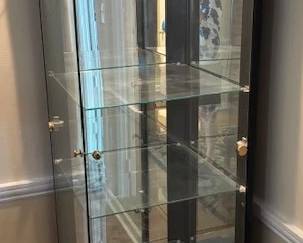 Black glass lighted display cabinet.