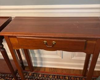 Three matching console tables.