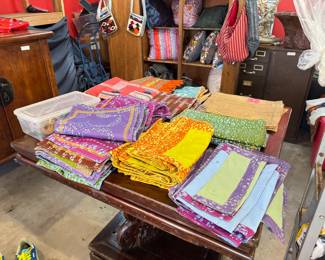 This Designer's Boutique is open and selling off all of its merchandise during this Estate Sale! So many colorful place settings to choose from! You won't find these in stores. They were curated, custom, and limited addition. The hall table they sit on has a beautifully carded base and the whole thing fits together like a puzzle. Shop for bags and boutique pillows during this sale too. All are discounted from the tagged prices