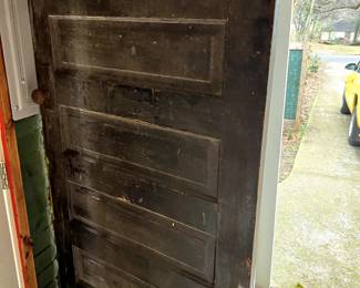 This antique solid wood door is large and in charge. Strip it and its original hardware and add it to your restored home