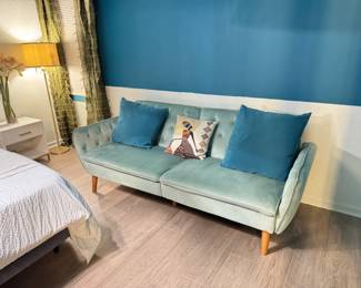 Curtains and sofa are for sale. This is a 6'+ long, teal green velvet sofa that converts to a full size bed.