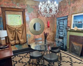 In this room, we are selling: Gunmetal and glass Dining table and 4 matching chairs with grey leather seats are all in great condition. Gold frame mirror, antique chandelier, wood console table with shelf and 2 sliding doors and 9'x11' rug, and all accessories (vases, candle holders, chargers, baskets, etc