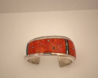 $3,000.  Jesse Monongya Navajo Hopi Sterling bracelet with intricate inlay.    Auction results last 6 months: $3,000-$6,000)
