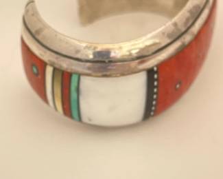 $3,000.  Jesse Monongya Navajo Hopi Sterling bracelet with intricate inlay.    Auction results last 6 months: $3,000-$6,000)