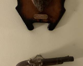 Decorative ceramic pistols and deer antelope.