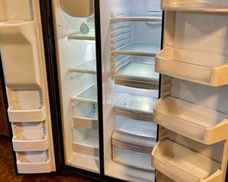 Black GE Side by Side Refrigerator/Freezer.