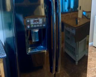 Black GE Side by Side Refrigerator/Freezer.