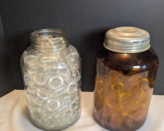 Tall Glass Jars Holding Small Glass Domes