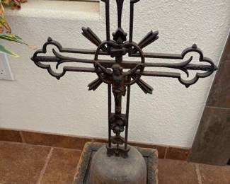 Ornate antique wrought iron cross on stand
