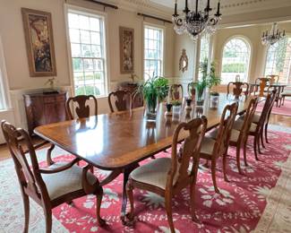 Georgian design mahogany dining table by RBC (made in England). Mahogany table has rounded corners and a satinwood and burr walnut banding. Table has two additional leaves.
