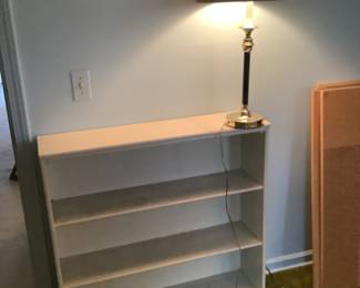 White wooden bookcase and lamp