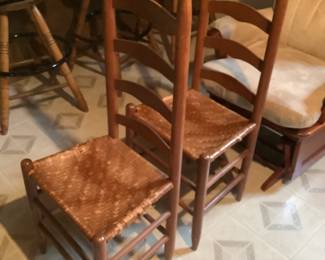 Two antique ladder back chairs with woven seats
