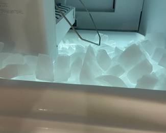 Kitchen fridge, ice maker is working, water connection is unhooked.
