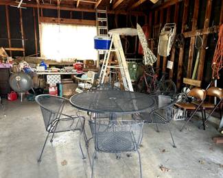 Black wrought iron mesh table, 4 chairs, table and umbrells. lots of garage misc