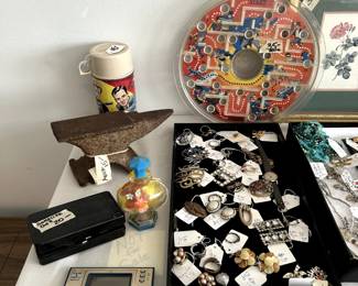 miss collectables to include a small anvil, Nintendo game and watch, bakelite case with syringe, liddle kiddle, Man from Uncle thermos, jewelry and print