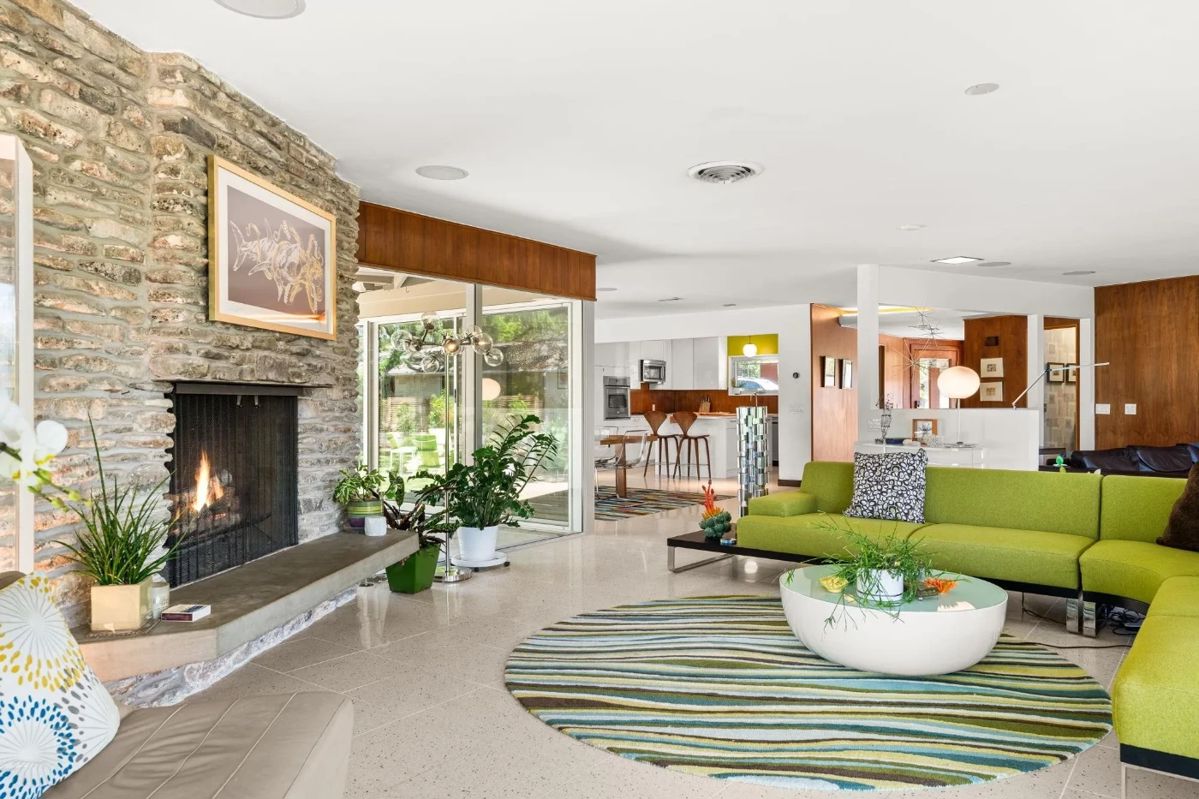 Living room: wrap-around sectional sofa, houseplants