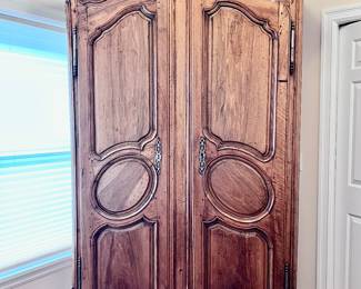 19th Century Antique French Louis XV Armoire. Crafted from rich walnut wood. This original antique, dating back to approx. 1870, reflects the intricate style of the Louis XV period. With its solid wood finish and historic value, this armoire is a testament to the craftsmanship of the late 19th century.