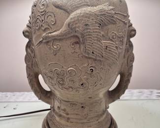 Vintage lamp with flying crane design and ornate handles.