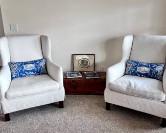 Pair of white wingback chairs