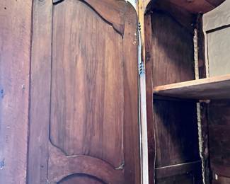 19th Century Antique French Louis XV Armoire. Crafted from rich walnut wood. This original antique, dating back to approx. 1870, reflects the intricate style of the Louis XV period. With its solid wood finish and historic value, this armoire is a testament to the craftsmanship of the late 19th century.