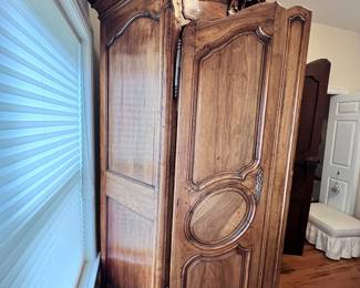 19th Century Antique French Louis XV Armoire. Crafted from rich walnut wood. This original antique, dating back to approx. 1870, reflects the intricate style of the Louis XV period. With its solid wood finish and historic value, this armoire is a testament to the craftsmanship of the late 19th century.