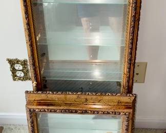 Gilt display cases for wall.