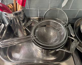 multiple pieces of all clad cookware - pots, pans, roasters and more