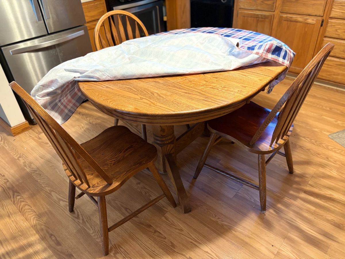 . . . oak dining room table and three chairs