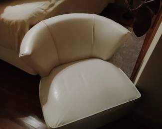 Mid-century modern swivel, white, leather chair.